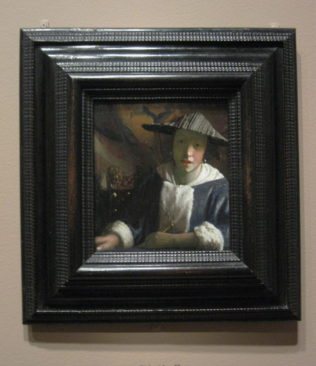 Girl with a Flute by Johannes Vermeer in its frame