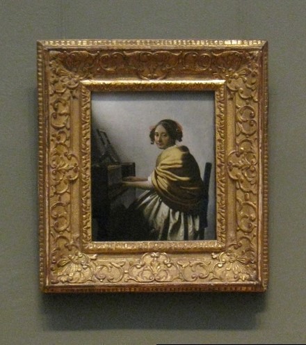 A Young Woman Seated at the Virginal (attributed to Johannes Vermeer) with frame
